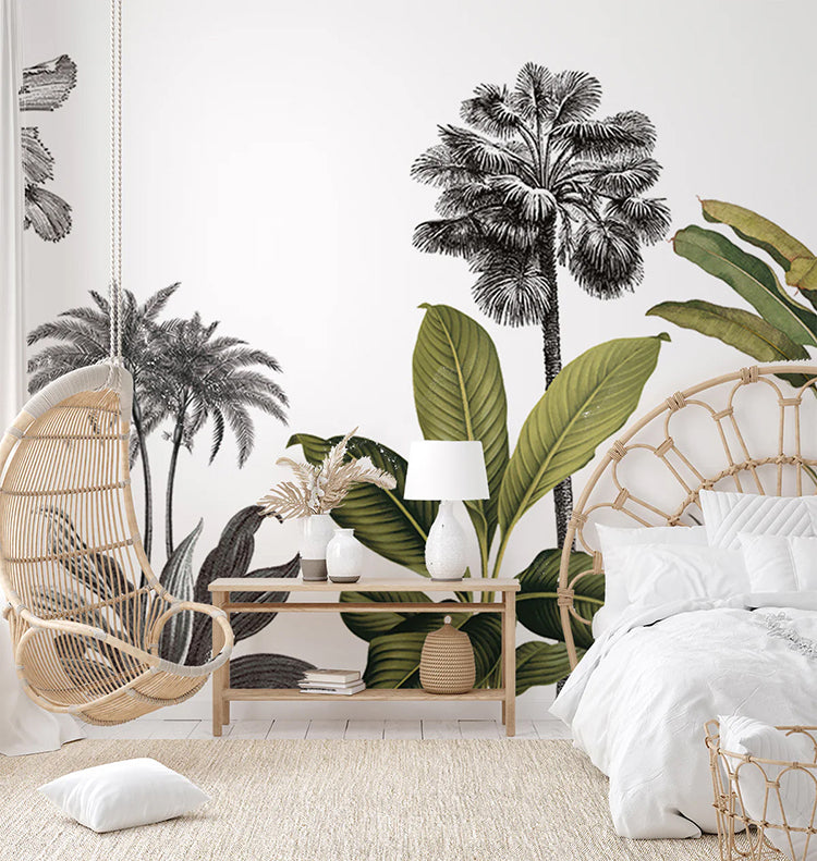 A peaceful bedroom with Forest Dreams, Mural Wallpaper. The room features a hanging rattan chair, a wooden bench with a lamp and plants, a cozy white bed, and a woven rug.