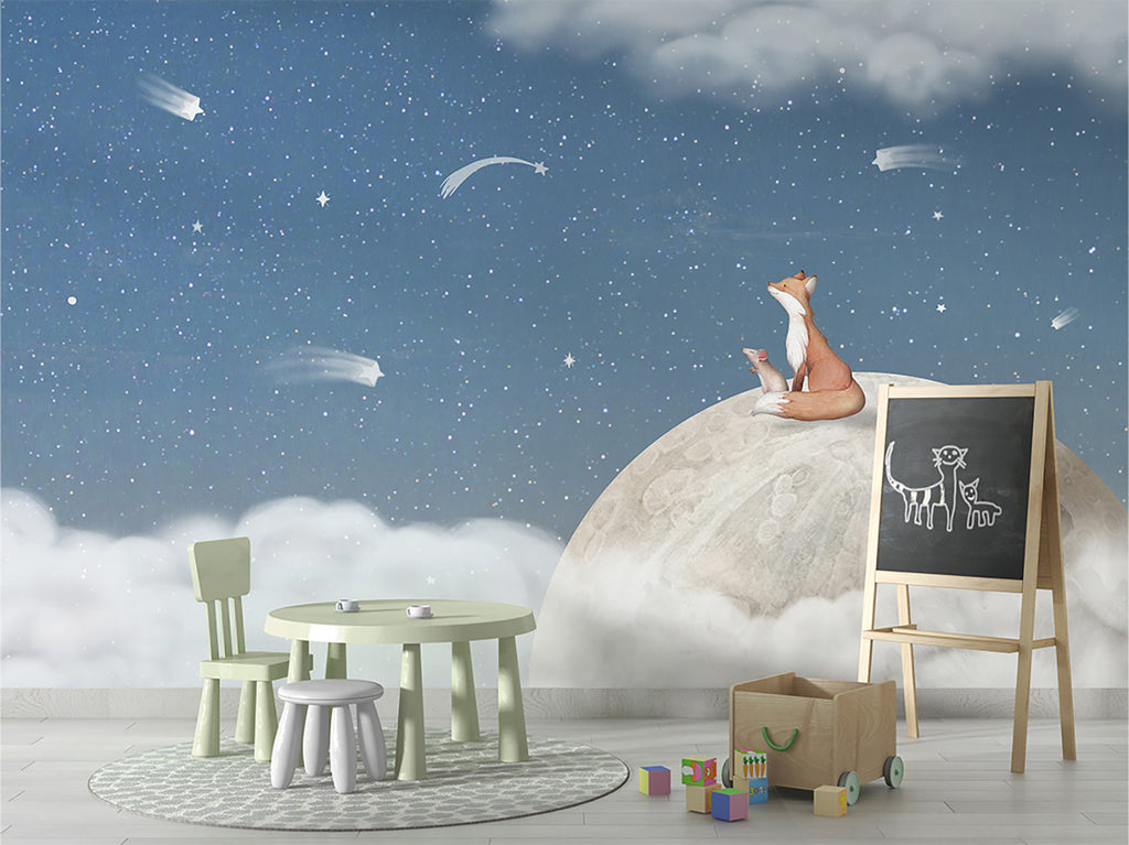 A whimsical scene in a child’s room that has a mini green round table with stools and chairs. It features Fox on the Moon, Mural Wallpaper in Blue, depicting a fox sitting atop a moon surrounded by clouds and stars, creating a serene and imaginative atmosphere. This enchanting scene evokes a sense of wonder and imagination.