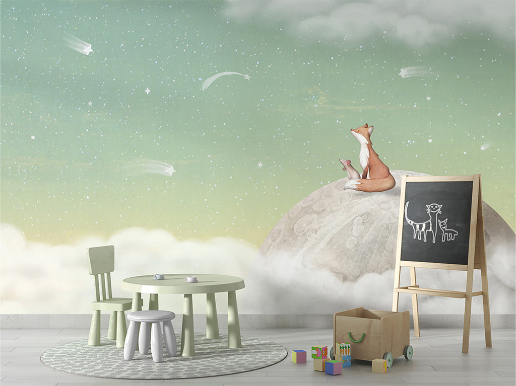 A whimsical scene in a child’s room that has a mini green round table with stools and chairs. It features Fox on the Moon, Mural Wallpaper in Green, depicting a fox sitting atop a moon surrounded by clouds and stars, creating a serene and imaginative atmosphere. This enchanting scene evokes a sense of wonder and imagination.