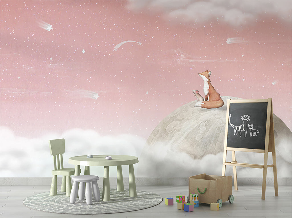 A whimsical scene in a child’s room that has a mini green round table with stools and chairs. It features Fox on the Moon, Mural Wallpaper in Pink, depicting a fox sitting atop a moon surrounded by clouds and stars, creating a serene and imaginative atmosphere. This enchanting scene evokes a sense of wonder and imagination.