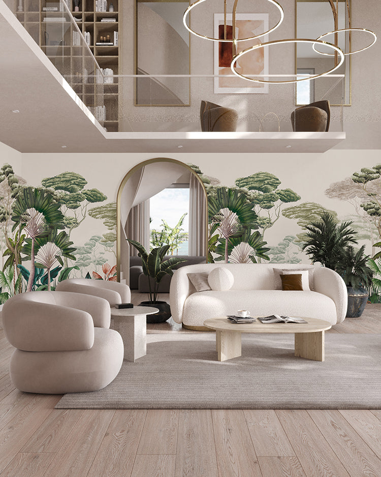 The room features a modern, well-lit living space. The focal point is the Garden Eden, Tropical Mural Wallpaper in Dark Green, which showcases lush greenery and pink flowers. Complementing this naturalistic theme are a beige sofa set, a wooden coffee table, and elegant hanging lights.