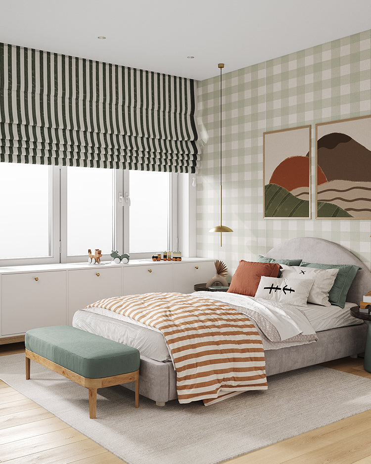 A cozy and stylish bedroom featuring Gingham, Patterned Wallpaper in Green. The room includes a comfortable bed with striped bedding, a green upholstered bench, modern artwork, and a window with striped blinds