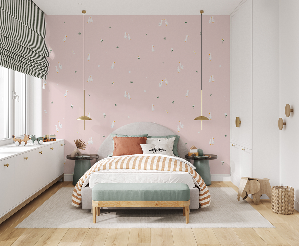 Bedroom with pink Graceful Geese wallpaper, gray bed, striped bedding, pendant lights, wooden accents, and playful decor.