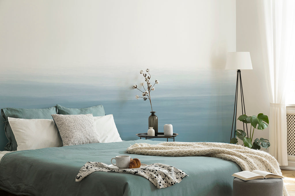 Serene bedroom with a soothing Gradient Ombre, Mural Wallpaper  in Light Blue. The wallpaper features tranquil blue tones transitioning from dark to light, complementing the room’s peaceful ambiance.