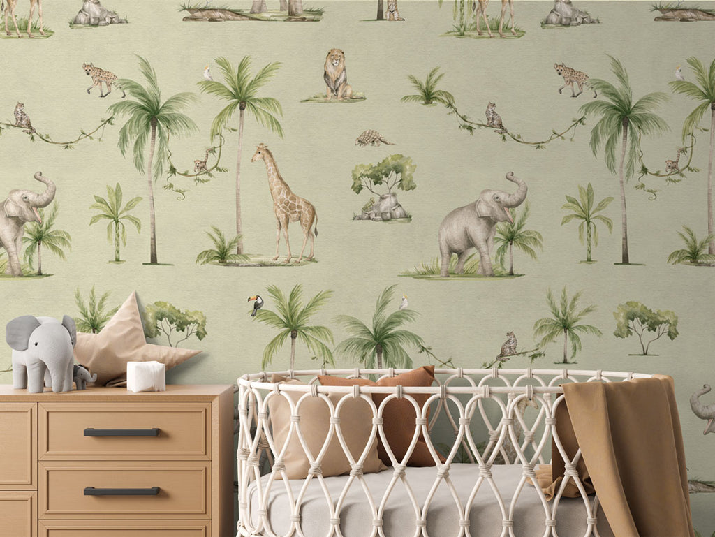 Joyful Jungle, Pattern Wallpaper in green colourway. The nursery room includes a wooden dresser with an elephant plush toy, and a crib with a brown blanket.
