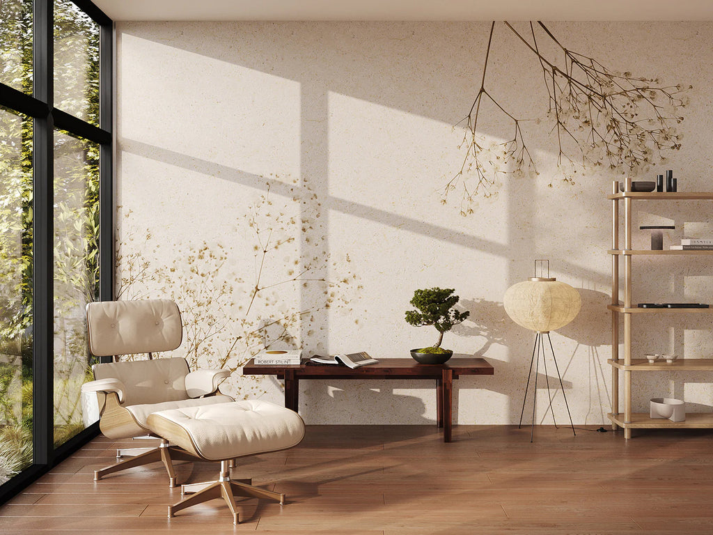 A minimalist living room bathed in natural light filtering through floor-to-ceiling windows. Kasumisou, Japanese Mural Wallpaper featuring delicate floral motifs complements the neutral color palette and wooden furniture. A bonsai tree and paper lantern enhance the serene atmosphere.
