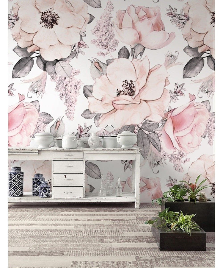 Stylish interior featuring Kiela Flowers Pattern Wallpaper with large pink and white blooms on a light background, accented by a white console table, decorative ceramics, and green plants.