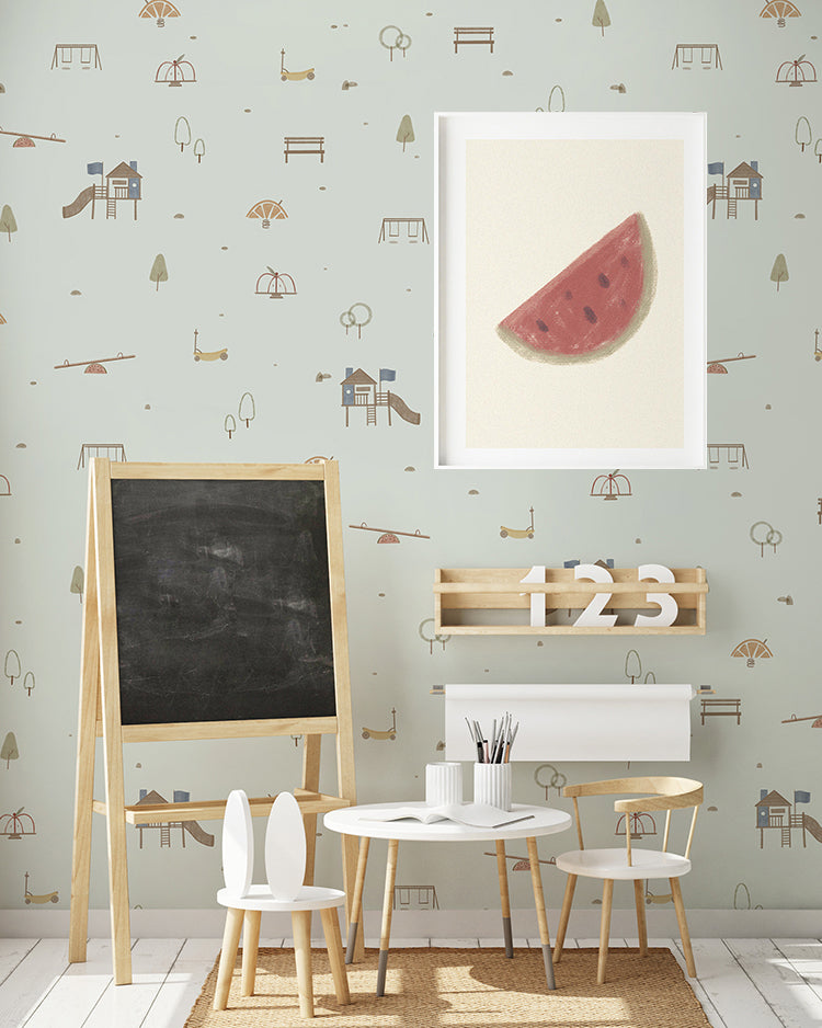 A vibrant children’s room featuring the ‘Mini Fruitful Play, Pattern Wallpaper in Dusky Blue. The room includes a blackboard, a wooden shelf with numbers, and a white desk with chairs, creating a playful and educational environment.