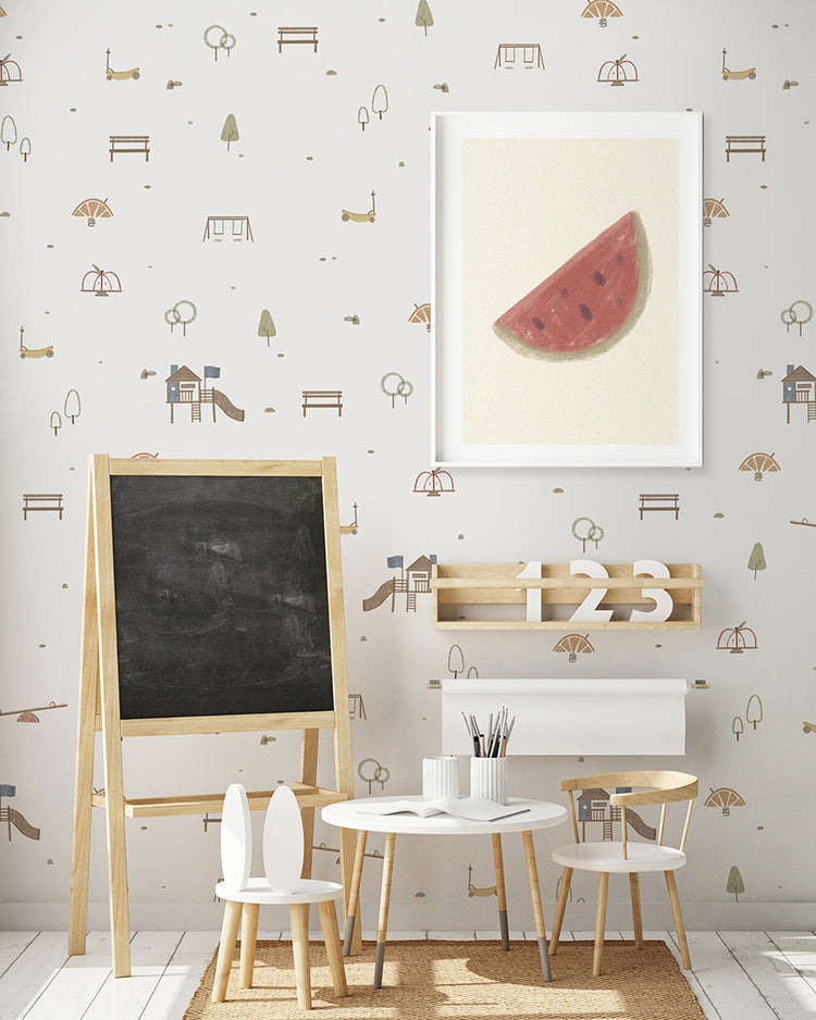 A vibrant children’s room featuring the ‘Mini Fruitful Play, Pattern Wallpaper in White. The room includes a blackboard, a wooden shelf with numbers, and a white desk with chairs, creating a playful and educational environment.