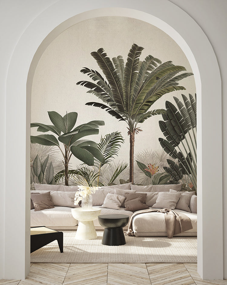 An arched doorway reveals a room adorned with Palm Paradise, Tropical Mural Wallpaper in Green. Lush green palm trees and tropical foliage contrast beautifully with the modern, neutral-toned furniture, creating a tranquil, tropical haven within a stylish interior.
