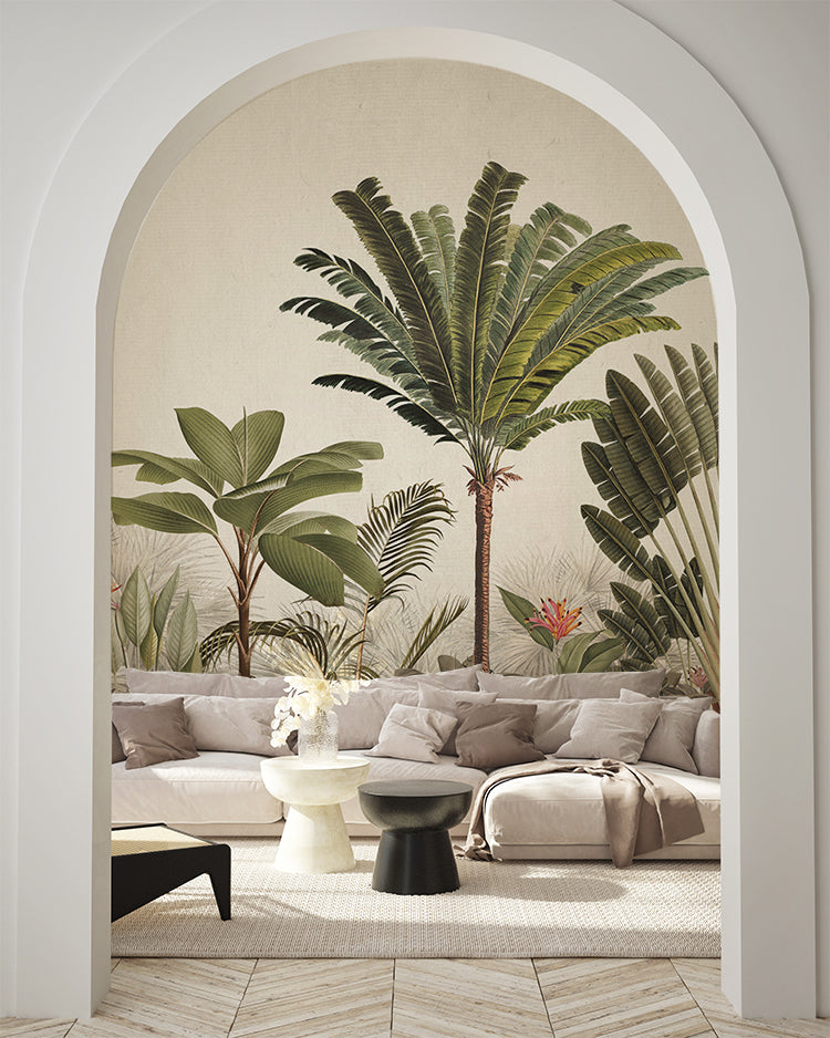 An arched doorway reveals a room adorned with Palm Paradise, Tropical Mural Wallpaper in Honey. Honey green palm trees and tropical foliage contrast beautifully with the modern, neutral-toned furniture, creating a tranquil, tropical haven within a stylish interior.