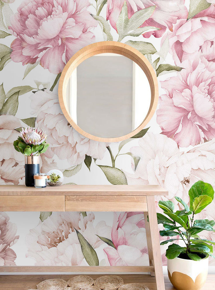 Peonies Garden, Floral Pattern Wallpaper in Blush Pink, featuring large pink peonies and lush green leaves on a light background. A wooden mirror and console table with potted plants accentuate the serene ambiance.