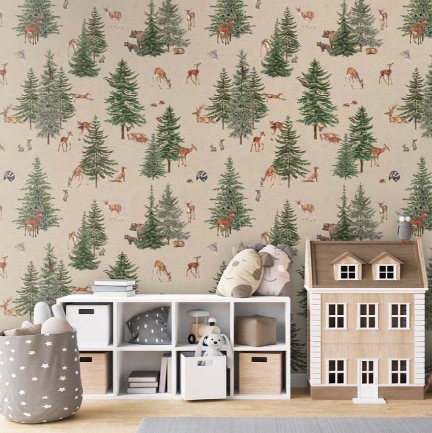 Pine forest, Pattern Wallpaper in sand colourway, the children's room includes a white storage unit with cubbies containing toys, books, and storage bins. On top of the storage unit, there are plush toys, a small wooden house, and a decorative owl. A string of star-shaped decorations hangs down on the right. A grey storage basket with white stars, filled with plush toys, adds to the playful and organized atmosphere.