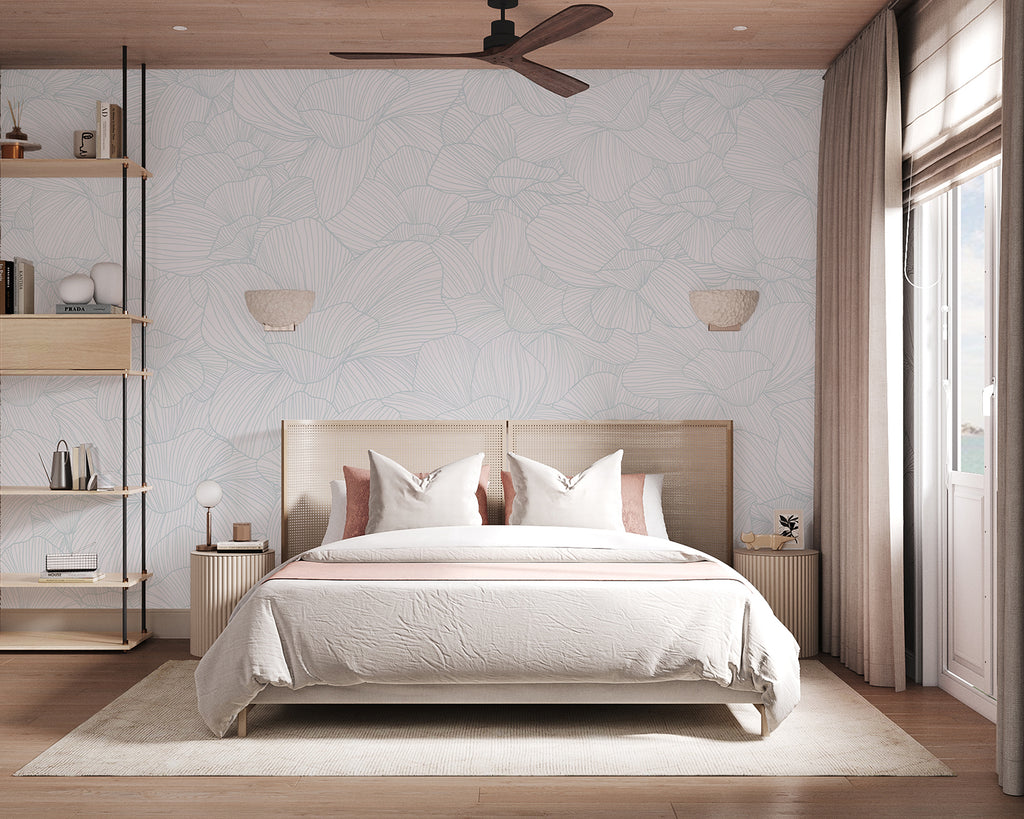 Serene bedroom with Saltwater Blooms, Pattern Wallpaper in Blue. Features include a cozy double bed, wooden side tables, wall-mounted lamps, a ceiling fan, and a window with sheer curtains. The room exudes a warm, inviting atmosphere.