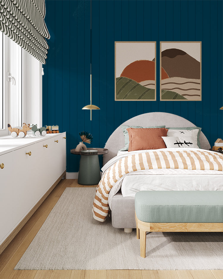 Inviting bedroom adorned with deep blue Shiplap, Vertical Striped Wallpaper. The room features a cozy bed with striped bedding, abstract wall art, a plush bench, and a dresser filled with toys, creating a harmonious and well-decorated space.