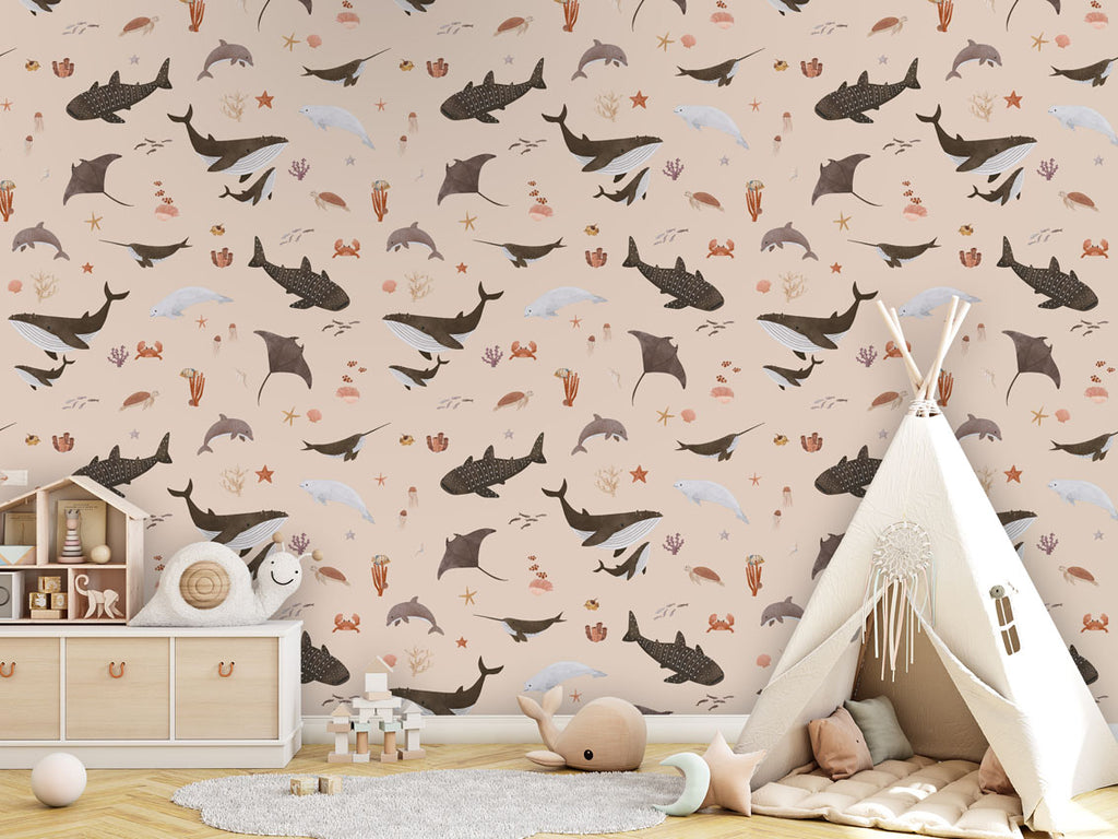 A playroom with beige Splendid Sea wallpaper, a teepee tent, a wooden toy set, and marine-inspired patterns on the wall.