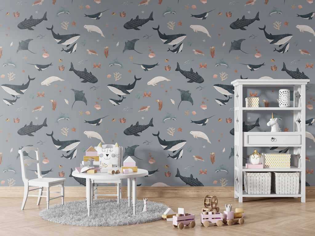 Kids' space with blue Splendid Sea wallpaper, a round table, toy shelf, and playful decor creating a whimsical underwater theme.