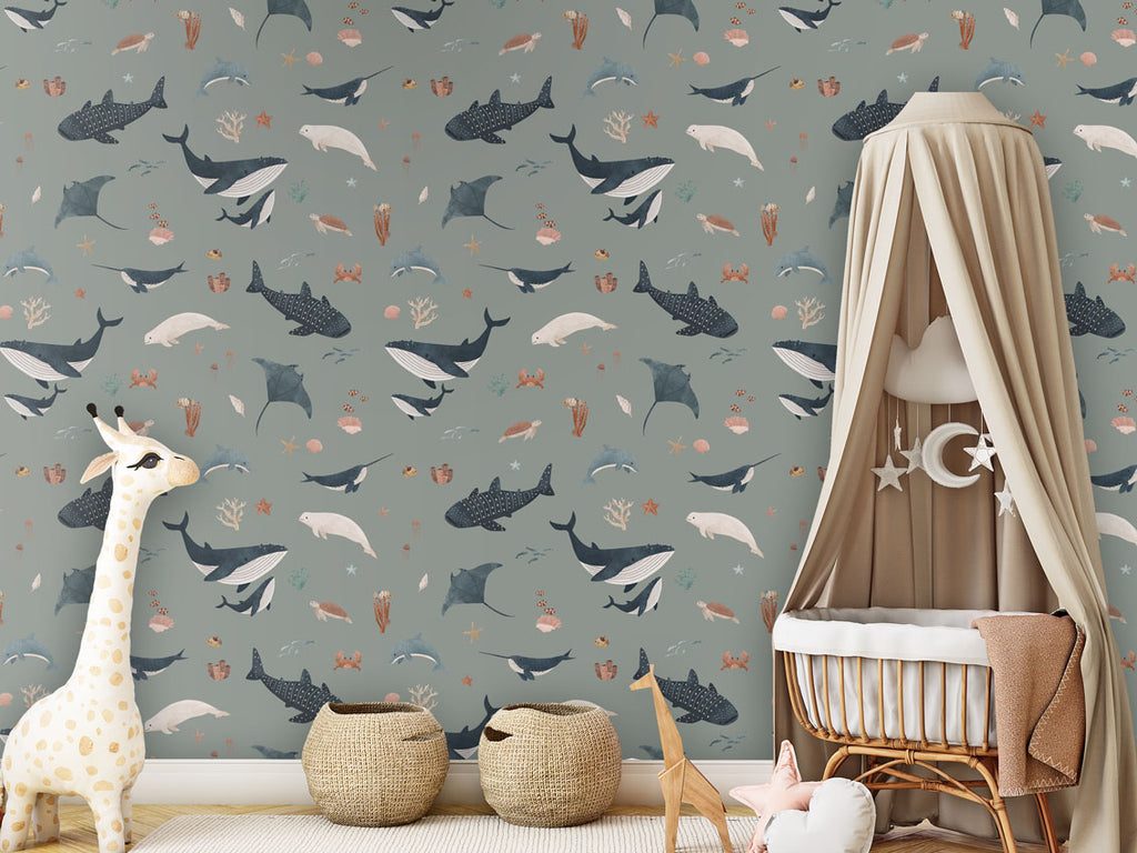 A cozy playroom with green Splendid Sea wallpaper, a canopy crib, a giraffe plushie, and woven storage baskets.