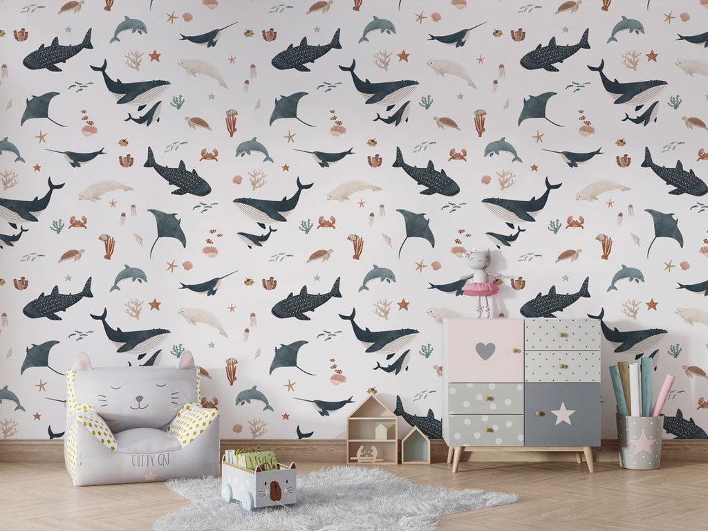 Bright playroom adorned with Splendid Sea white wallpaper, highlighted by marine animals and pastel storage drawers.