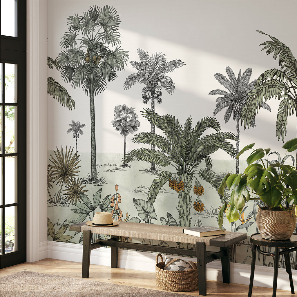 A serene room adorned with the Vintage Palmscape, Tropical Mural Wallpaper in Green. Detailed palm tree illustrations grace the walls, creating a tranquil ambiance. A sleek wooden bench holds a lamp, books, and vases, seamlessly complementing the tropical theme.