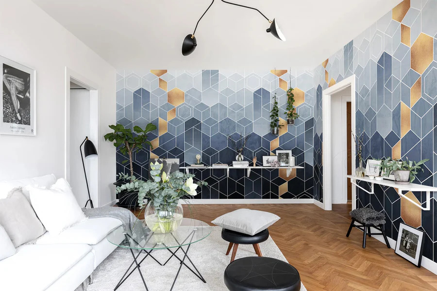 HC-Geometric_Blue___Gold_Pattern_Wallpaper-Interior1-18122023_900x.jpg Living room with a sofa, a transparent glass coffee table and tv console, with geometric blue & gold wallpaper