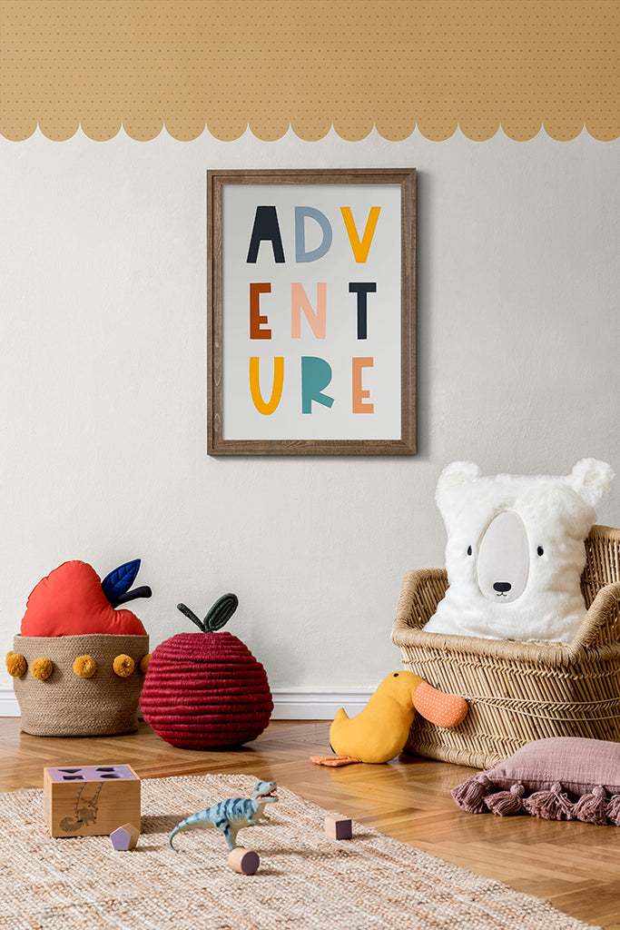A vibrant children’s playroom filled with an array of colorful toys and educational games. The room is adorned with whimsical art pieces that echo the playful energy of the room. The stylish Scallops Trimmings wallpaper in Clay enhances the inviting atmosphere.