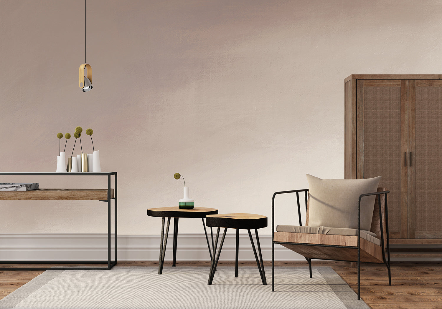 Modern minimalist room featuring the Stella Skies, Ombre Wallpaper in Blush Pink transitioning from a dark to light shade. The room is furnished with a metal console table, round side table, cushioned armchair, and a wooden cabinet. A pendant light illuminates the space.
