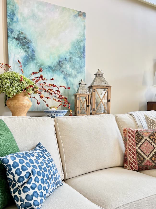 Mediterranean living room concept with beige linen sofa decorated with ethnic pattern sofa pillows