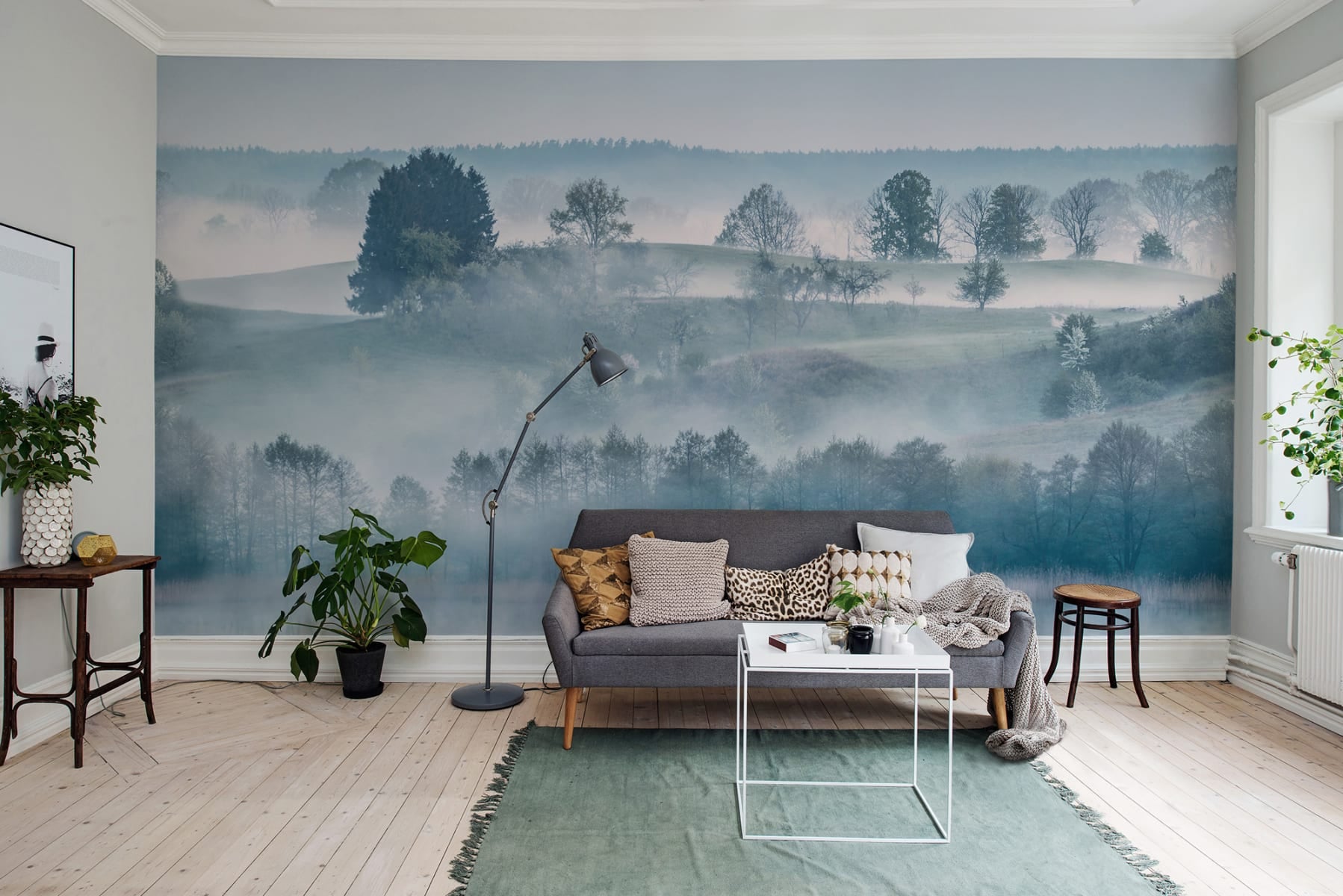 HC-Morning_Haze_Blue_Landscape_Wallpaper-Interior1-18122023.jpg Leopard Landscape, Animal Mural Wallpaper, seen in a bathroom with a large round mirror hanging on the wall, giving it an elegant look, which makes the overall atmosphere of this bathroom one of relaxation and comfort.