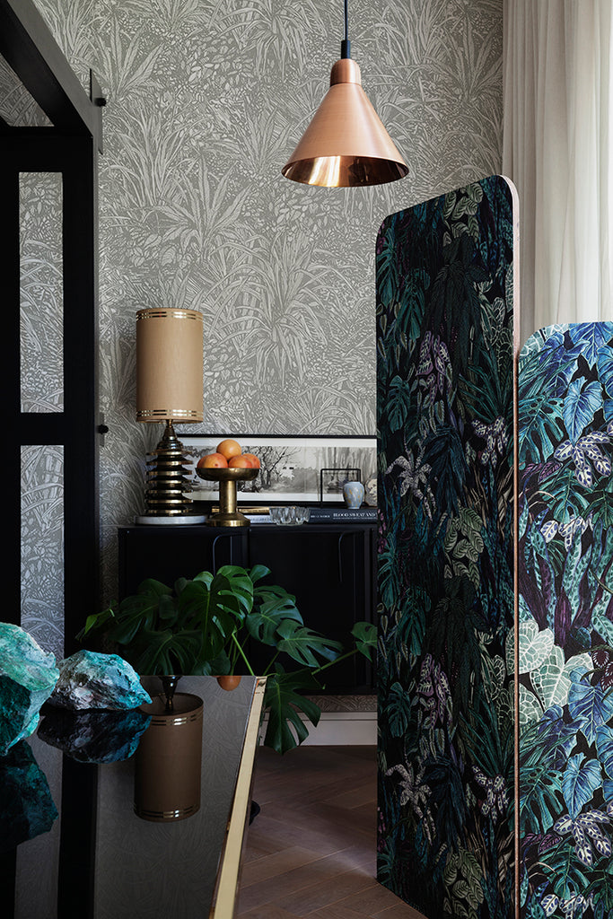 Amazon, Botanical Pattern Wallpaper in Stratos Grey featured in a room with rattan chairs, pillows and magazines on the ground