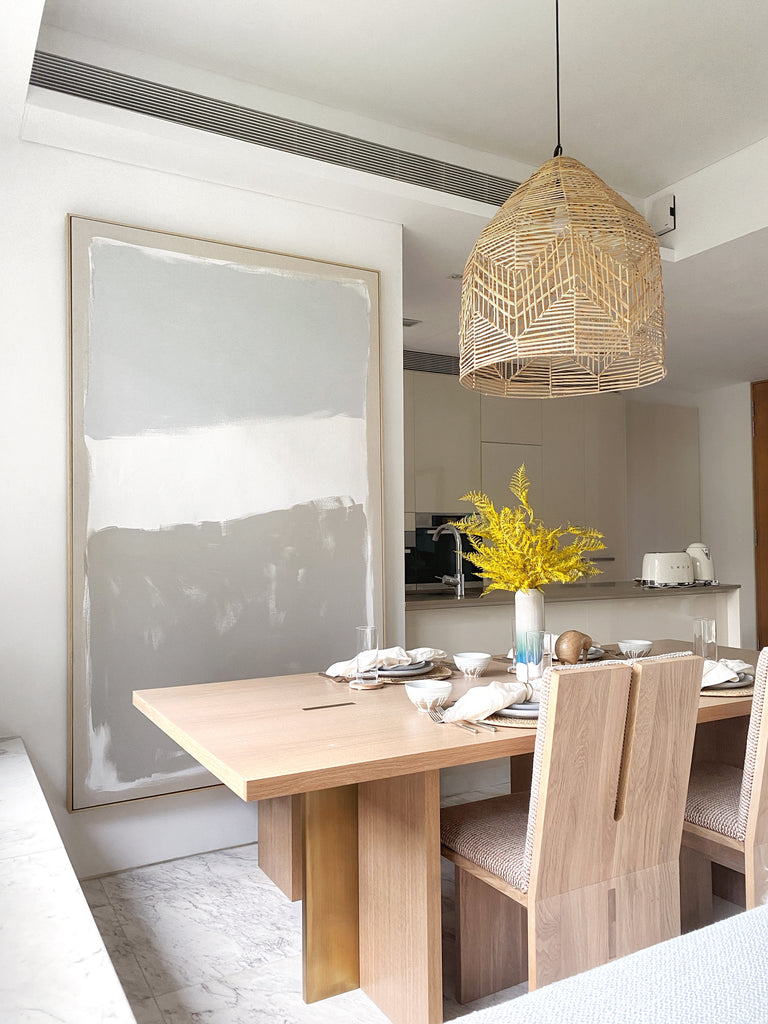 Dining room with wooden table and oversized art frame